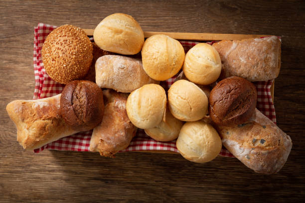 istock Fresh bread  on a wooden table, top view 1208018789