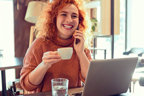 istock Redhead woman talking on smart phone 1208019836