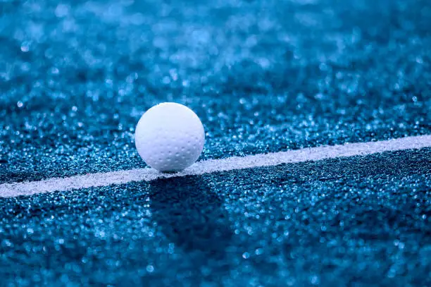 Photo of White ball for playing field hockey. Blue filter