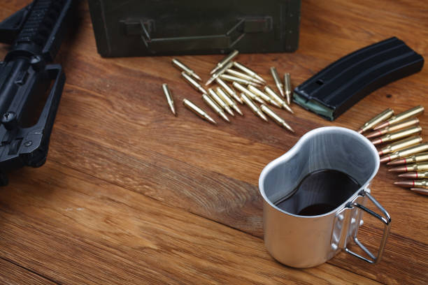 istock rifle and cup of coffee on wooden table 1208022082