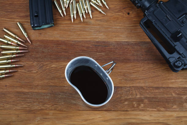 istock rifle and cup of coffee on wooden table 1208022378