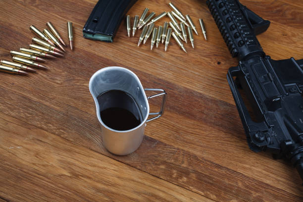 istock rifle and cup of coffee on wooden table 1208022436