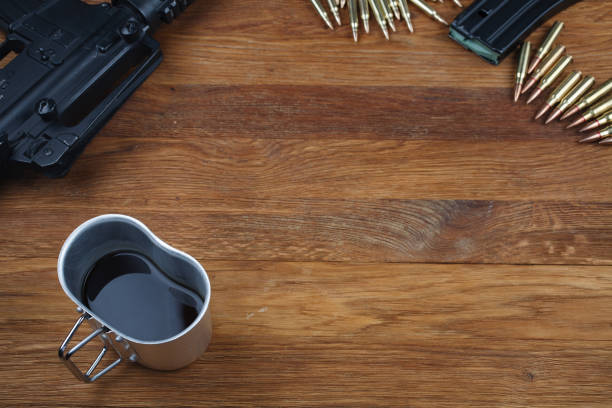 istock rifle and cup of coffee on wooden table 1208022491