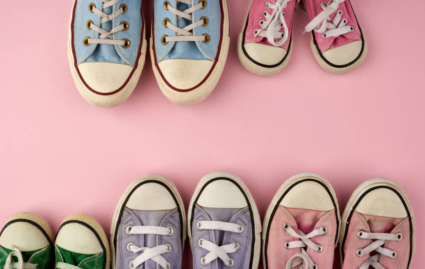 istock many multi-colored well-worn textile sneakers of different sizes on a pink background 1208022606