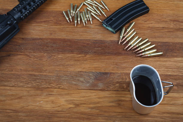 istock rifle and cup of coffee on wooden table 1208023241