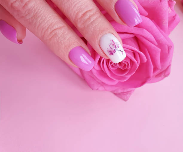 istock female hands holding a gift box, a bouquet of roses on a colored background 1208025521
