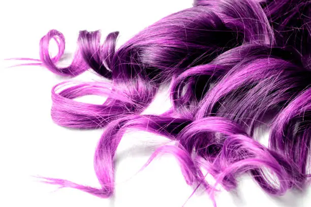 Photo of extreme purple hair color on white isolated background