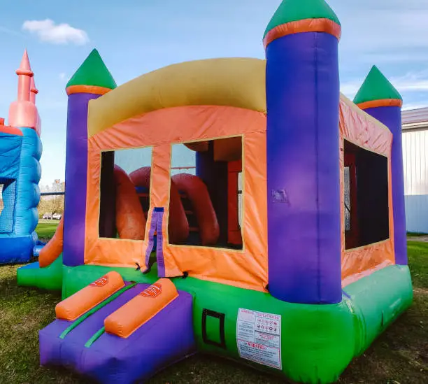 Photo of Colorful square children's bounce house with oranges, blues, greens and yellows