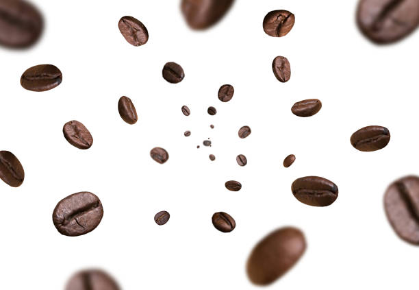 Dark brown roasted coffee beans falling on white background. Concept for coffee product advertising. Selective Focus. Dark brown roasted coffee beans falling on white background. Concept for coffee product advertising. Selective Focus. roasted coffee bean photos stock pictures, royalty-free photos & images