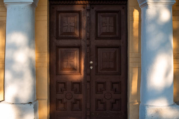 istock Church doorway wooden leaf mixed shadows comfortable sunny beautiful copy space text 1208033527