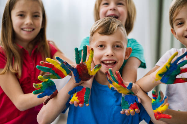 istock Group of children with colored hands 1208039499