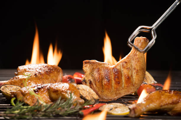 istock Grilled chicken thigh with various vegetables on the flaming grill 1208043168