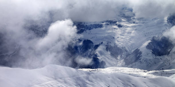 istock Off-piste slope in sunlight clouds 1208044789