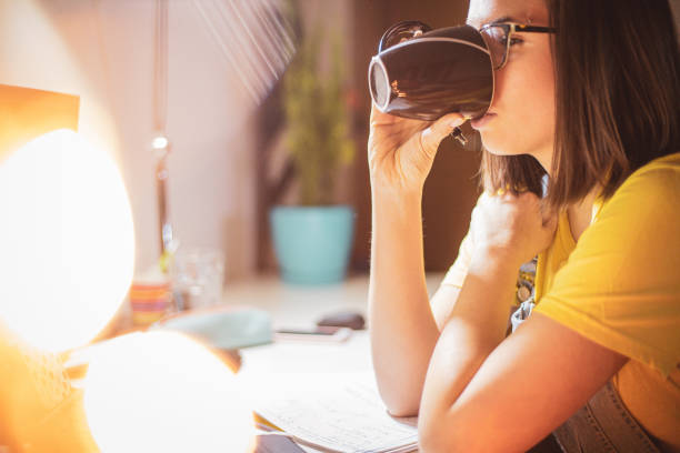 istock Young woman studying at home 1208045975
