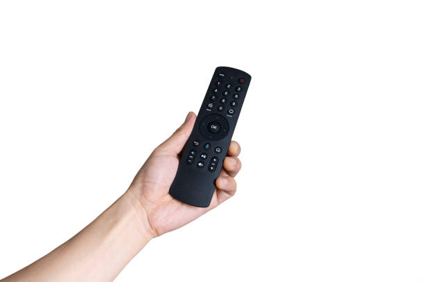 istock His hand is holding the remote control and operate the remote control. on the White Background . Concept of Technology 1208059834