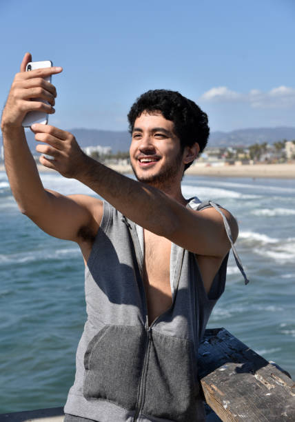 istock Handsome young man taking a selfie on a pier 1208059911