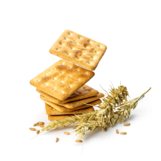 Stack of delicious bran crackers levitate on white background