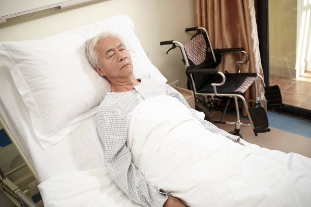 istock asian old man lying on back on hospital bed 1208062509