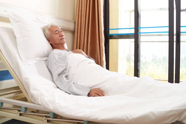 istock asian old man lying on back on hospital bed 1208062520