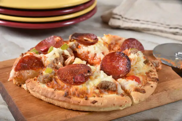 Photo of A sliced mini pepperoni and sausage pizza