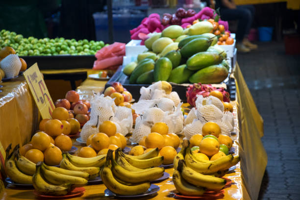 istock Assorted fresh fruits on display at a market stall 1208064977