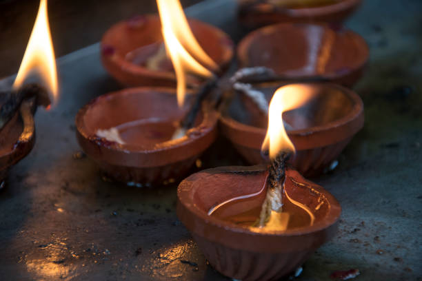 istock Traditional burning lit diya clay oil lamps 1208065095