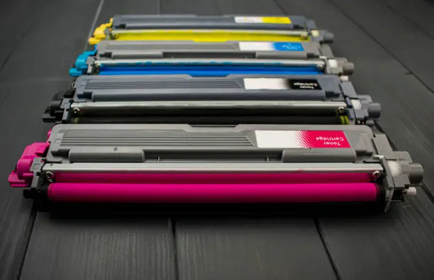Cyan, magenta, yellow and black color toner rollers of a foreground color laser printer