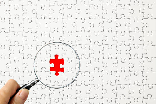 istock Search for missing puzzle pieces with a magnifying glass 1208080671