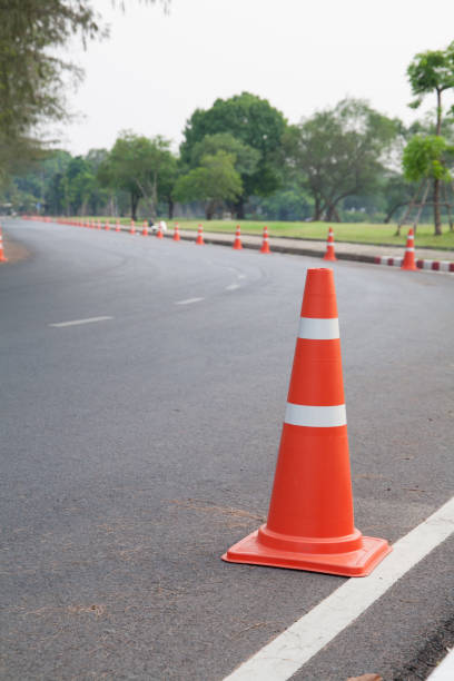 istock A closeup of traffic cone on grey curved asphalt 1208084205