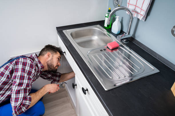 istock Plumber In Overall Fixing Sink Pipe 1208084957