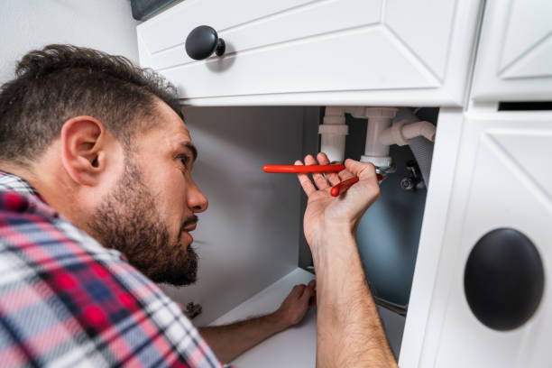 istock Plumber In Overall Fixing Sink Pipe 1208085061