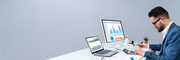 istock Man Working With Invoices And Charts 1208085210