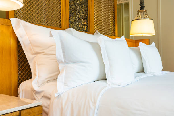 istock Comfortable white pillow on bed decoration in bedroom 1208089412