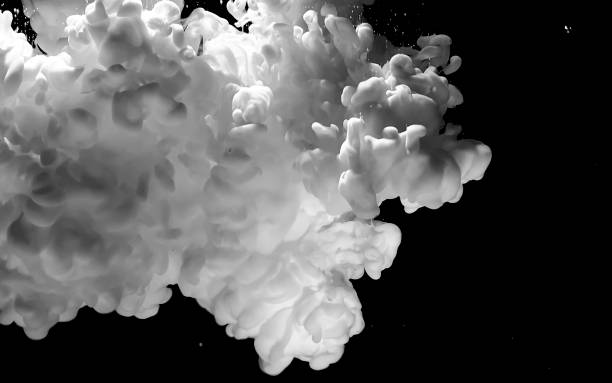 istock White watercolor ink in water on a black background. Space background. 1208090475