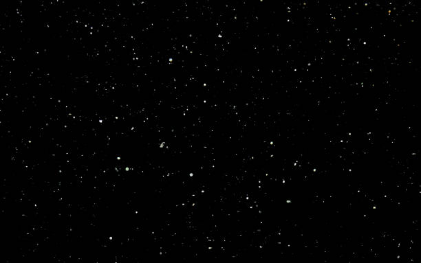 istock Snowfall background. White snow on a black sky. Winter background. 1208090515