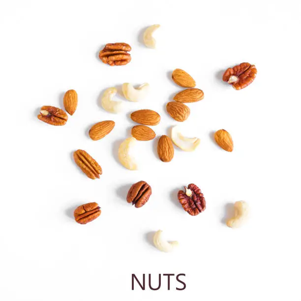 Nuts isolated on white background. Various nuts assortment: pecan, almond, cashew, walnut, healthy eating design elements, copy space.