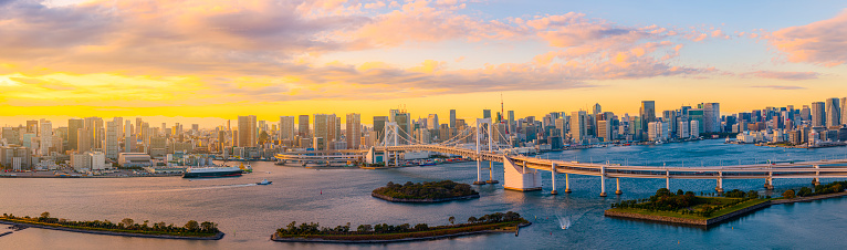 Panoramic Aerial view of Tokyo skylines with Rainbow bridge and tokyo tower over Tokyo bay in daytime from Odaiba in Tokyo city Kanto Japan. panorama photo of city in japan.