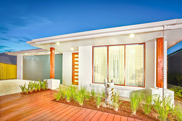 istock Modern home with wooden facade and grass on the ground 1208098031