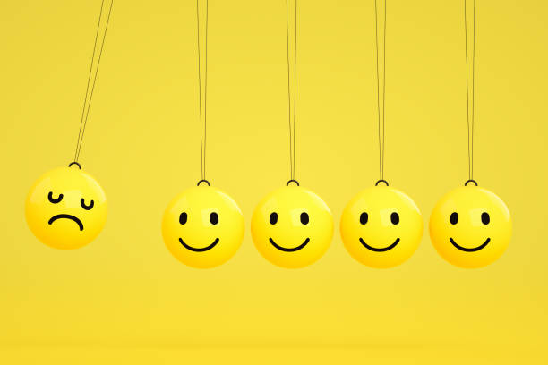 istock 3D Emoji with Smiley and Sad Face on Newton's Cradle 1208098924