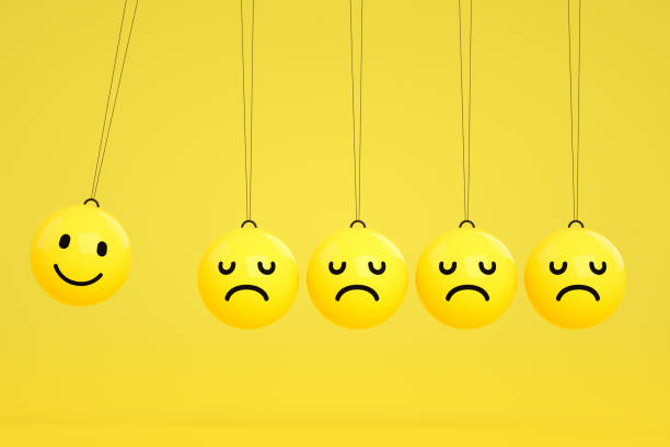 istock 3D Emoji with Smiley and Sad Face on Newton's Cradle 1208098978