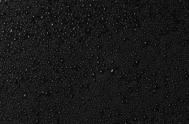 istock Water drops on black glass surface. Texture. Top view 1208099529