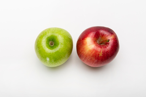Red and green apples on white background