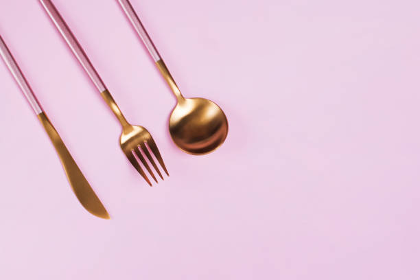 istock Elegant golden cutlery on black background 1208101628