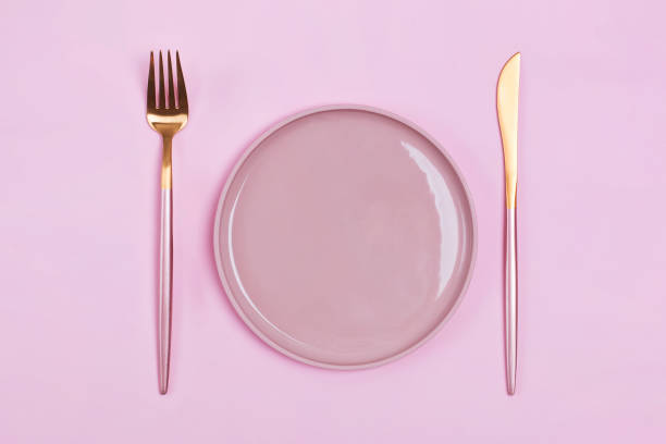 istock Empty pink plate and elegant cutlery, fork and knife on pastel bacgkround 1208101643