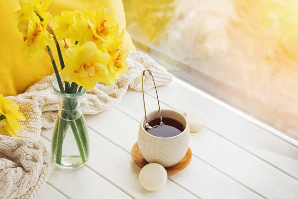 istock Spring still life with yellow flowers, tea and candle, 1208101889