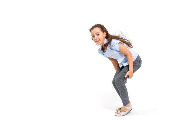istock little girl jumps on a white background 1208106211