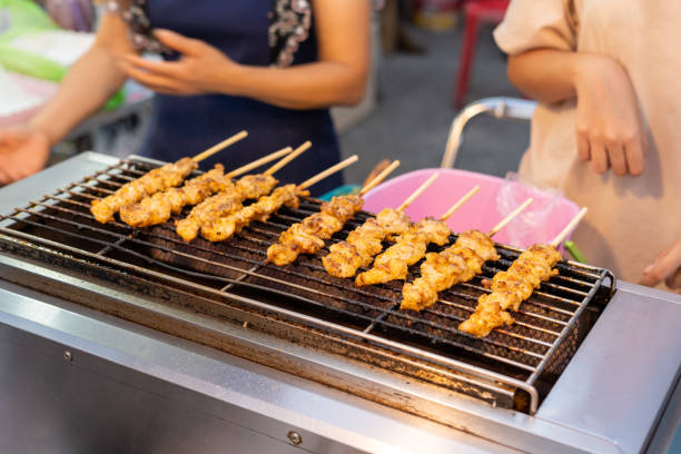 Crocodile meat grilled on a gas stove Sold at Amphawa floating market. Samut Songkhram Province, Thailand Grilled crocodile meat Which is sold at Amphawa Floating Market, Samut Songkhram, Thailand dangerous steak stock pictures, royalty-free photos & images