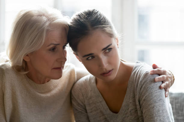 istock Aged mother calming grown up daughter close up image 1208113583