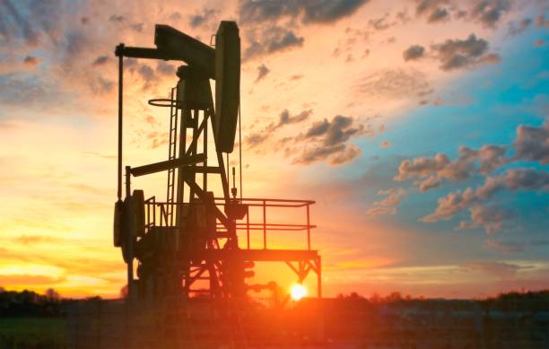 istock Silhouette of a work oil pump at sunset 1208115254