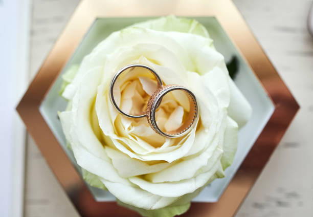 istock wedding rings lie on the table near a wedding bouquet 1208116557